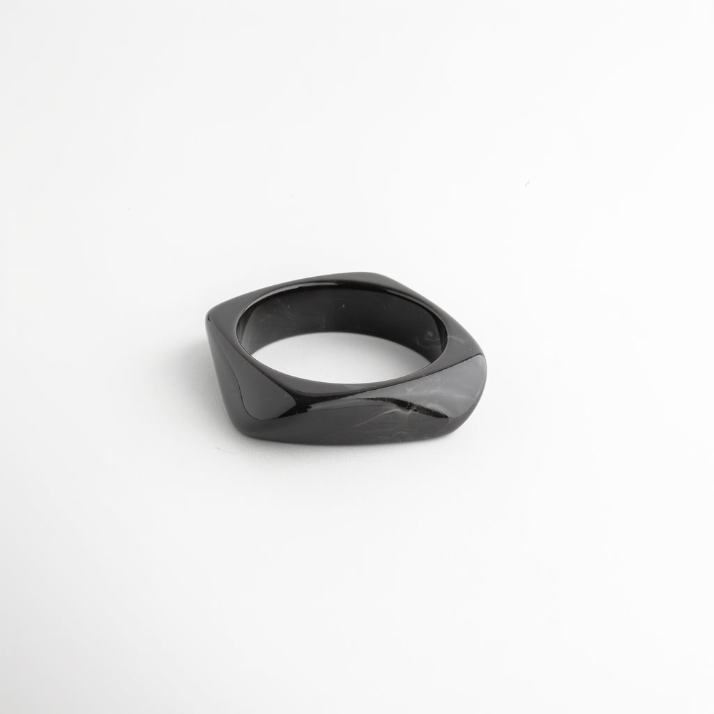 Pulsera negra de resina ángulo diagonal acabado brillante elegante, Pulsera cuff resina negra diseño orgánico detalle sofisticado, Pulsera moderna negra estilo contemporáneo minimalista, Pulsera ancha resina negra acabado pulido detalle diseño, Pulsera statement negra de resina forma fluida elegante