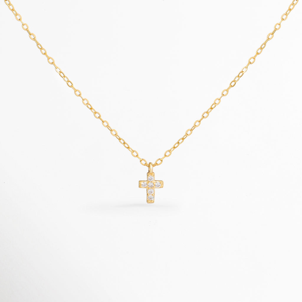 Collar Gloria con cruz mini de zirconias y acabado en oro 14K, Collar dorado con dije de cruz brillante elaborado en plata ley 925, Collar religioso elegante con cruz de zirconias y cadena delicada, Collar Gloria para mujer con diseño minimalista y cruz dorada, Collar con dije de cruz pequeña y zirconias para uso diario.