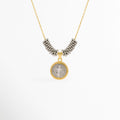 Collar Bitono San Benito enchapado en oro y oro blanco con medalla circular de San Benito y cuentas plateadas, vista de frente sobre fondo blanco, Vista frontal de collar religioso bitono con dije de medalla de San Benito de 2.2 cm flanqueado por cuentas plateadas tubulares, Plano general de collar protector bitono con dije circular de San Benito en relieve sobre cadena fina dorada con adorno de cuentas plata, Collar Bitono San Benito de cobre enchapado en oro
