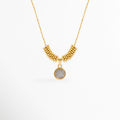 Collar Golden San Benito enchapado en oro con dije circular plateado de la medalla de San Benito y cuentas doradas, vista de frente sobre fondo blanco, Vista frontal de collar religioso con dije de medalla de San Benito de 1.7 cm flanqueado por cuentas doradas tubulares, Plano general de collar protector con dije circular de San Benito en relieve sobre cadena fina con adorno de cuentas, Collar Golden San Benito de cobre enchapado en oro mostrando el contraste