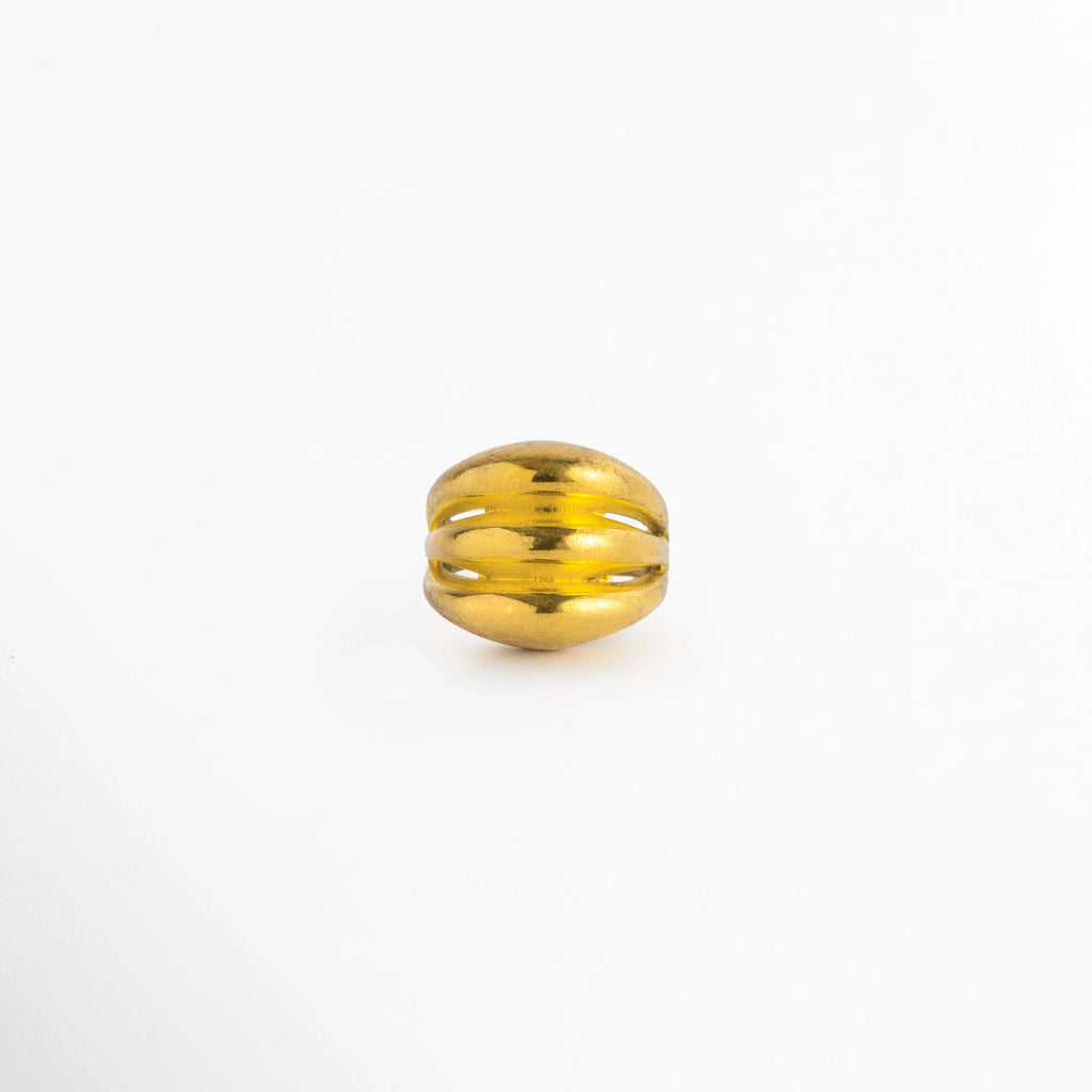 Anillo Cass de cobre enchapado en oro con cuerpo abombado de tres líneas o bandas acanaladas caladas, vista de frente sobre fondo blanco, Vista frontal de anillo dorado abombado con diseño escultural de tres aros fusiformes integrados y acabado de alto brillo, Plano general de anillo ajustarle enchapado en oro de estilo cúpula con tres franjas redondeadas y hendiduras caladas, Anillo Cass destacando el volumen tridimensional y los reflejos del baño dorado