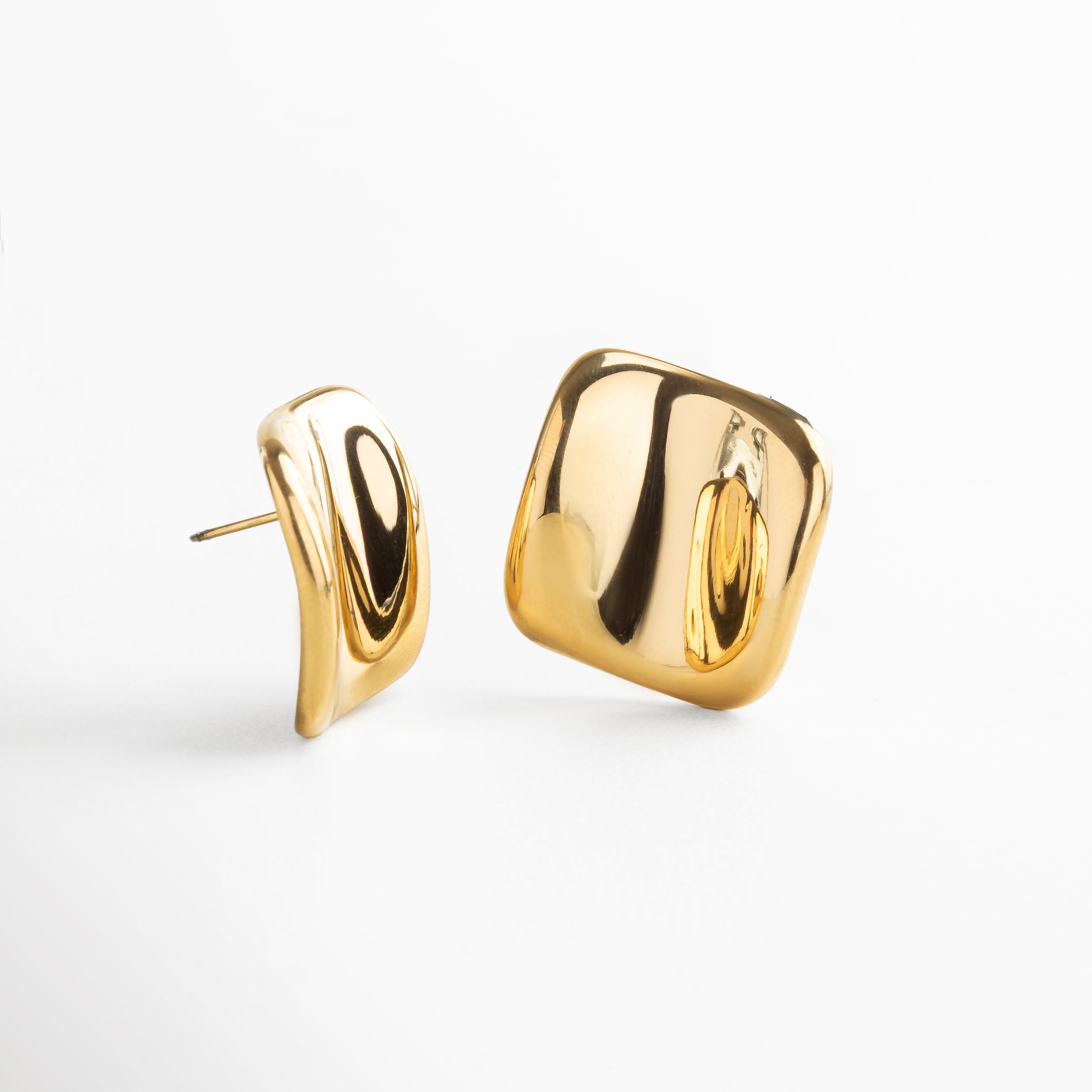 Detalle de textura abstracta en aretes cuadrados dorados, Primer plano de pendientes dorados con superficie artística, Close-up de acabado texturizado en pendientes geométricos, Acabado dorado brillante y texturizado en aretes cuadrados