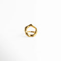Anillo dorado con diseño circular irregular y acabado pulido, una pieza moderna con inspiración escultórica.