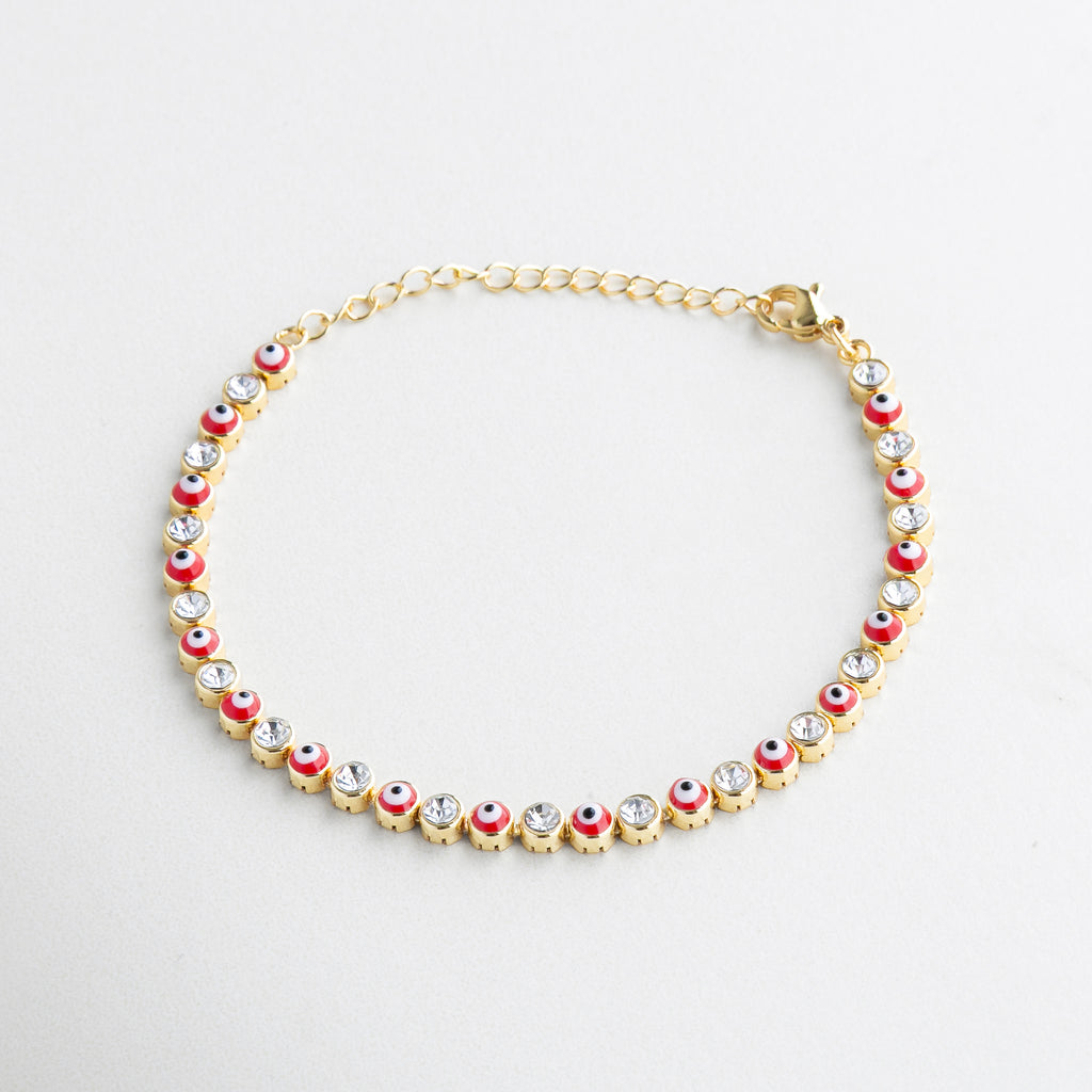 Pulsera roja con dijes de ojos turcos y zirconias, Diseño vibrante con detalles protectores en dorado, Pulsera fina de ojitos con incrustaciones brillantes, Joya con charms simbólicos y estilo moderno, Pulsera de hilo rojo con acentos dorados