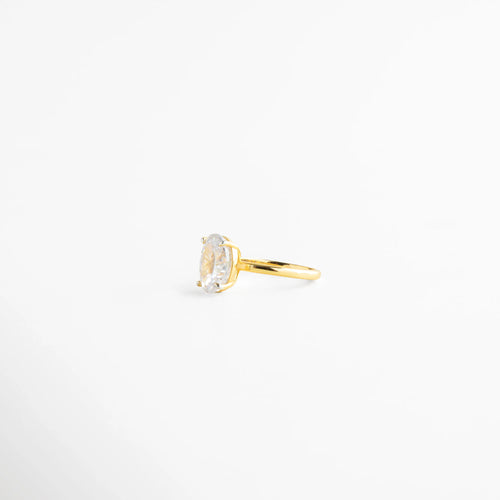 anillo dorado perfil delgado y elegante, anillo con piedra oval montura delicada, anillo fino dorado vista costado, joyería elegante anillo clásico, anillo dorado diseño limpio, anillo femenino sofisticado 