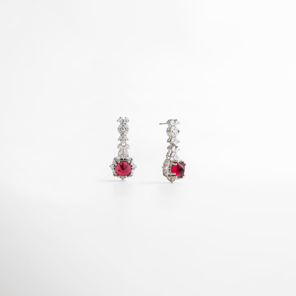 piedra rubí de imitación en corte cuadrado, color rojo intenso y vibrante, montura ornamental en plata esterlina, diseño refinado con acabados impecables, joya que aporta un toque de glamour