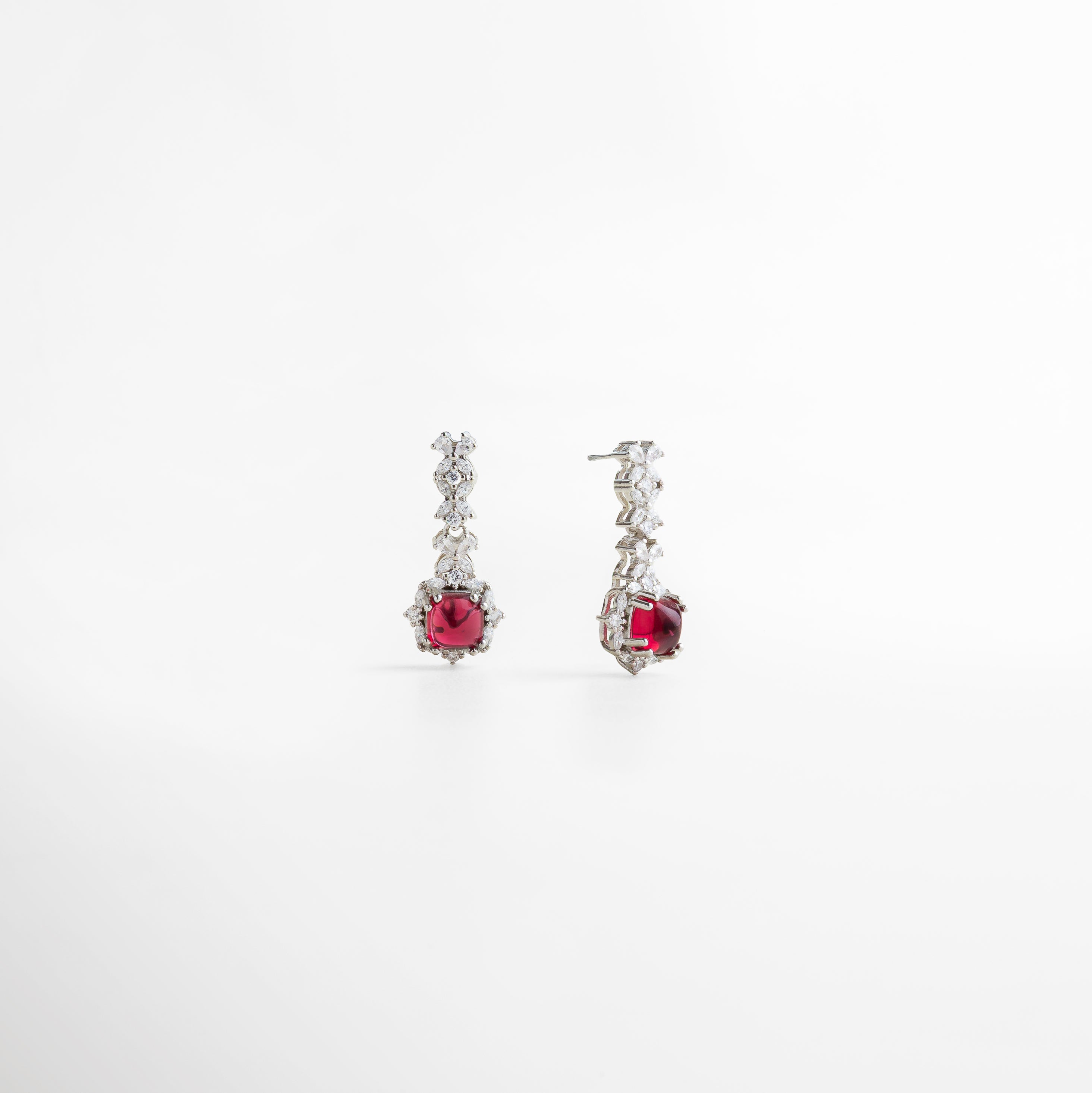 piedra rubí de imitación en corte cuadrado, color rojo intenso y vibrante, montura ornamental en plata esterlina, diseño refinado con acabados impecables, joya que aporta un toque de glamour