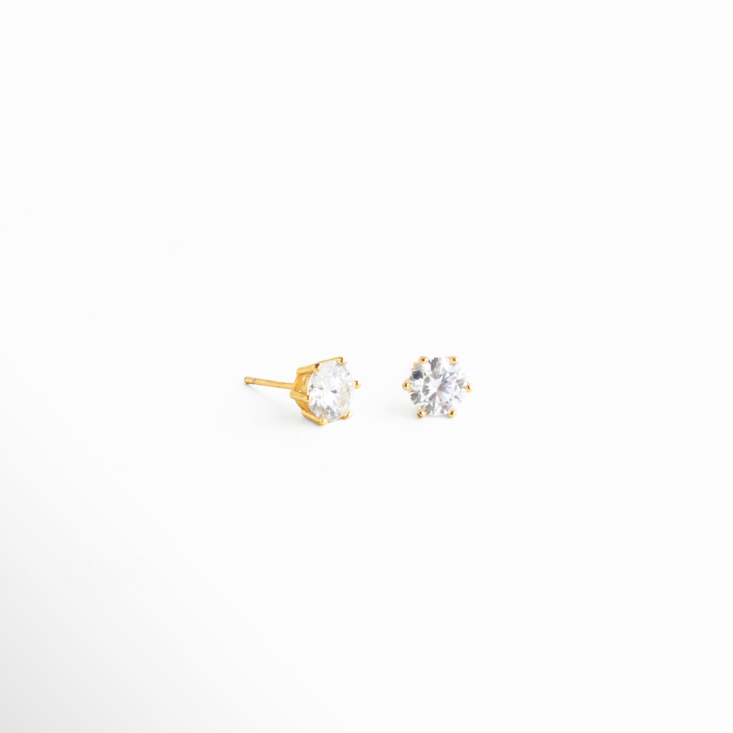 Aretes broquel de estrella vista lateral con zirconia, Perfil lateral de aretes pequeños con piedra brillante, Aretes delicados con estructura fina y estrella central, Joyería discreta con zirconia engastada en estrella, Aretes ligeros y cómodos para uso diario