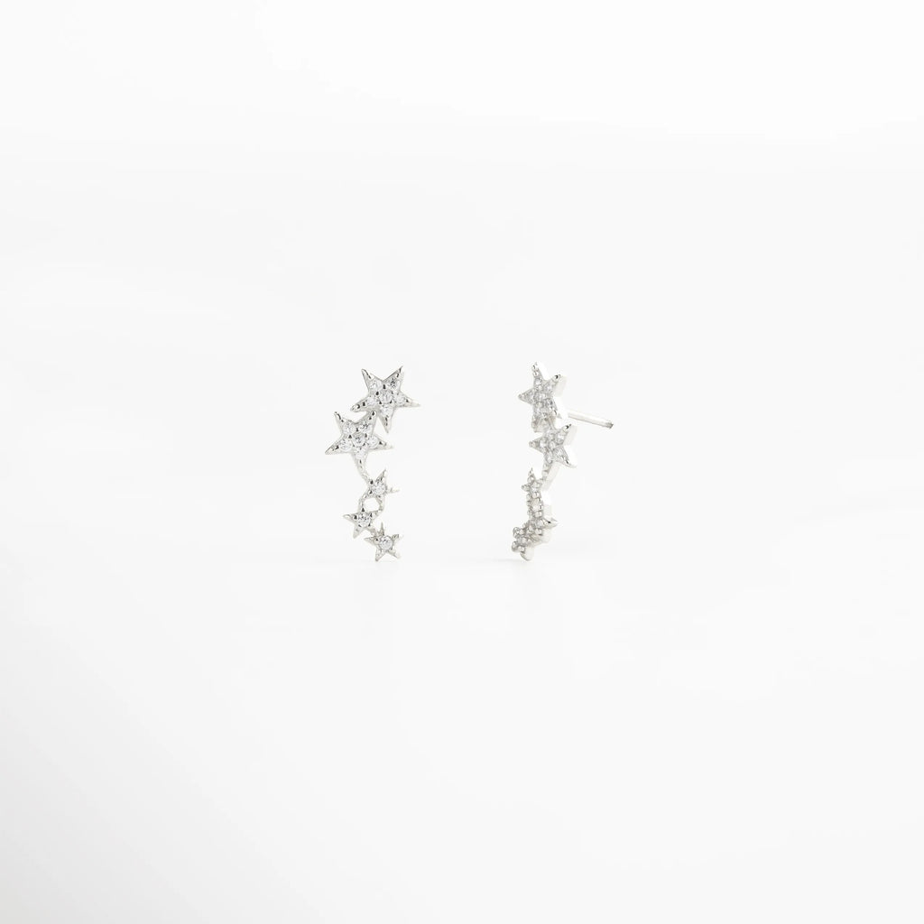 aretes de estrellas plateados, aretes colgantes delicados, joyería plateada femenina, aretes con brillo sutil, aretes románticos mujer, joyería inspirada en estrellas, aretes finos plateados, accesorios delicados