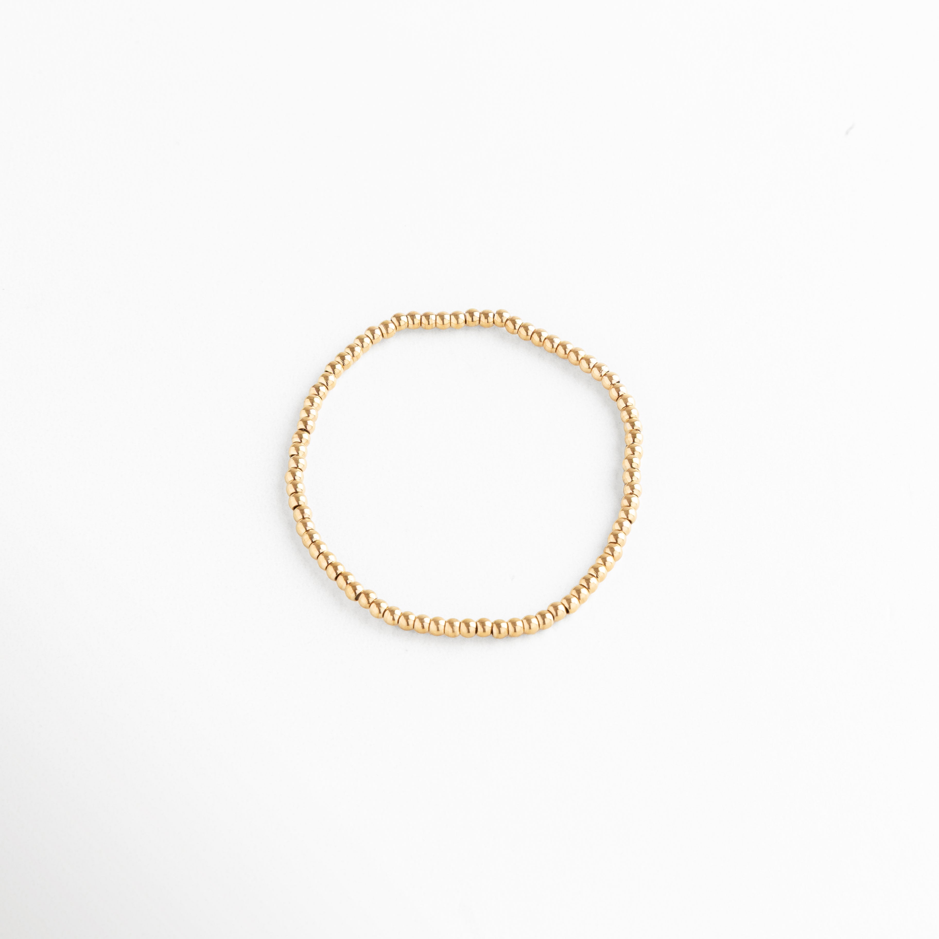 Pulsera de cuentas doradas elásticas minimalista, joyería moderna y versátil, Accesorio elegante dorado con cuentas redondas brillantes, pulsera básica atemporal.