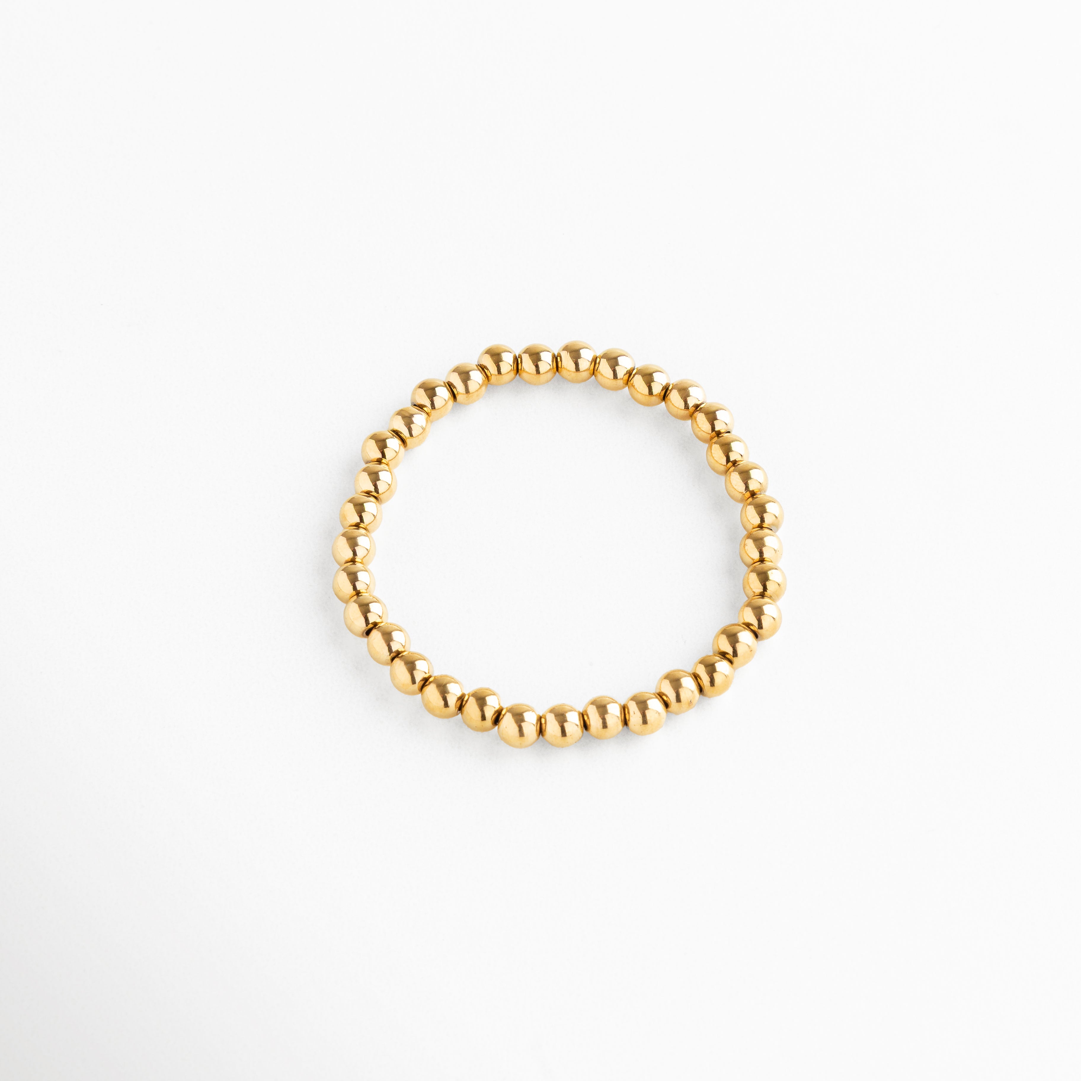 Pulsera de cuentas doradas grandes, diseño elástico con estilo sofisticado, Pulsera dorada minimalista de esferas grandes, accesorio elegante y llamativo.