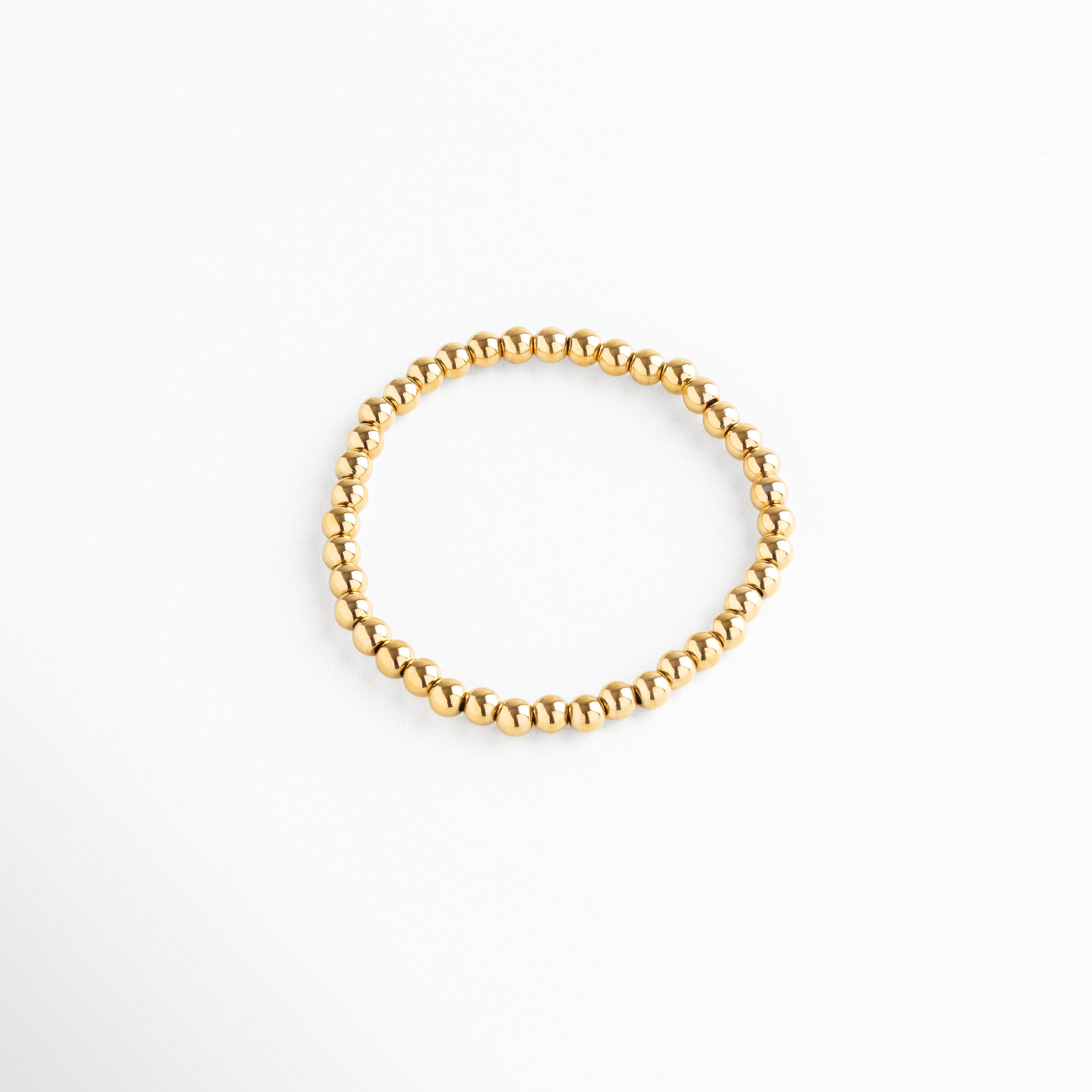 Pulsera de cuentas doradas medianas, diseño elástico y elegante, Pulsera dorada minimalista con esferas medianas, estilo moderno y versátil.