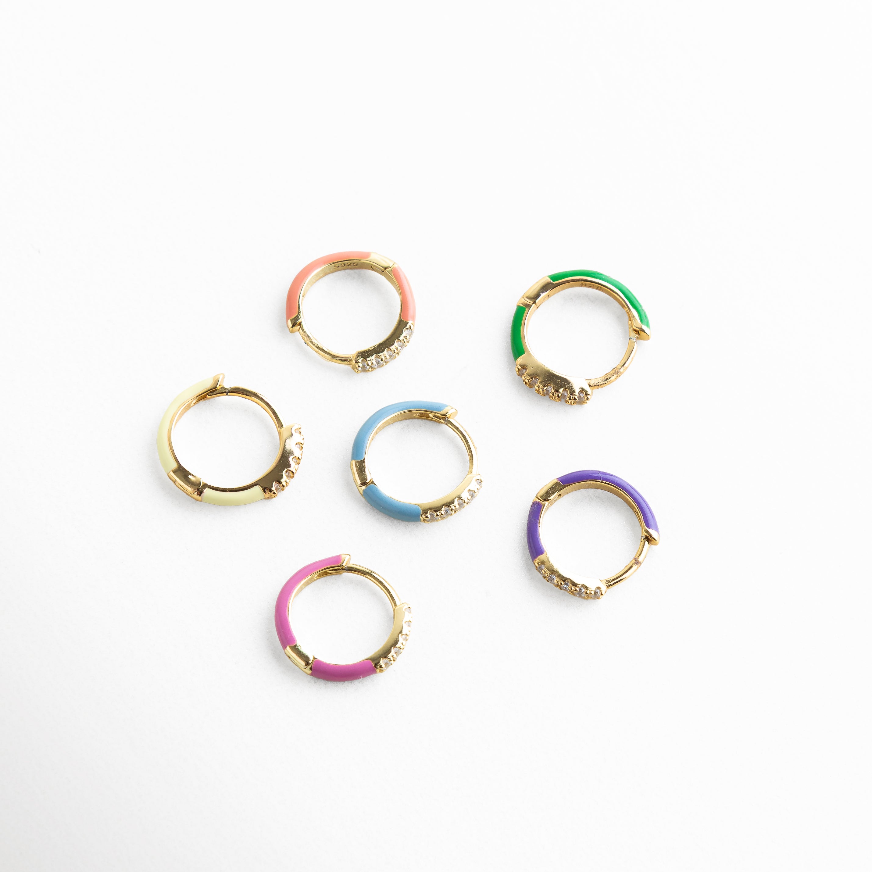 piercing aro pequeño vista superior, mini arete circular con esmalte de color, piercing fino dorado con incrustaciones, aro compacto para piercing elegante, joyería delicada para piercing diario