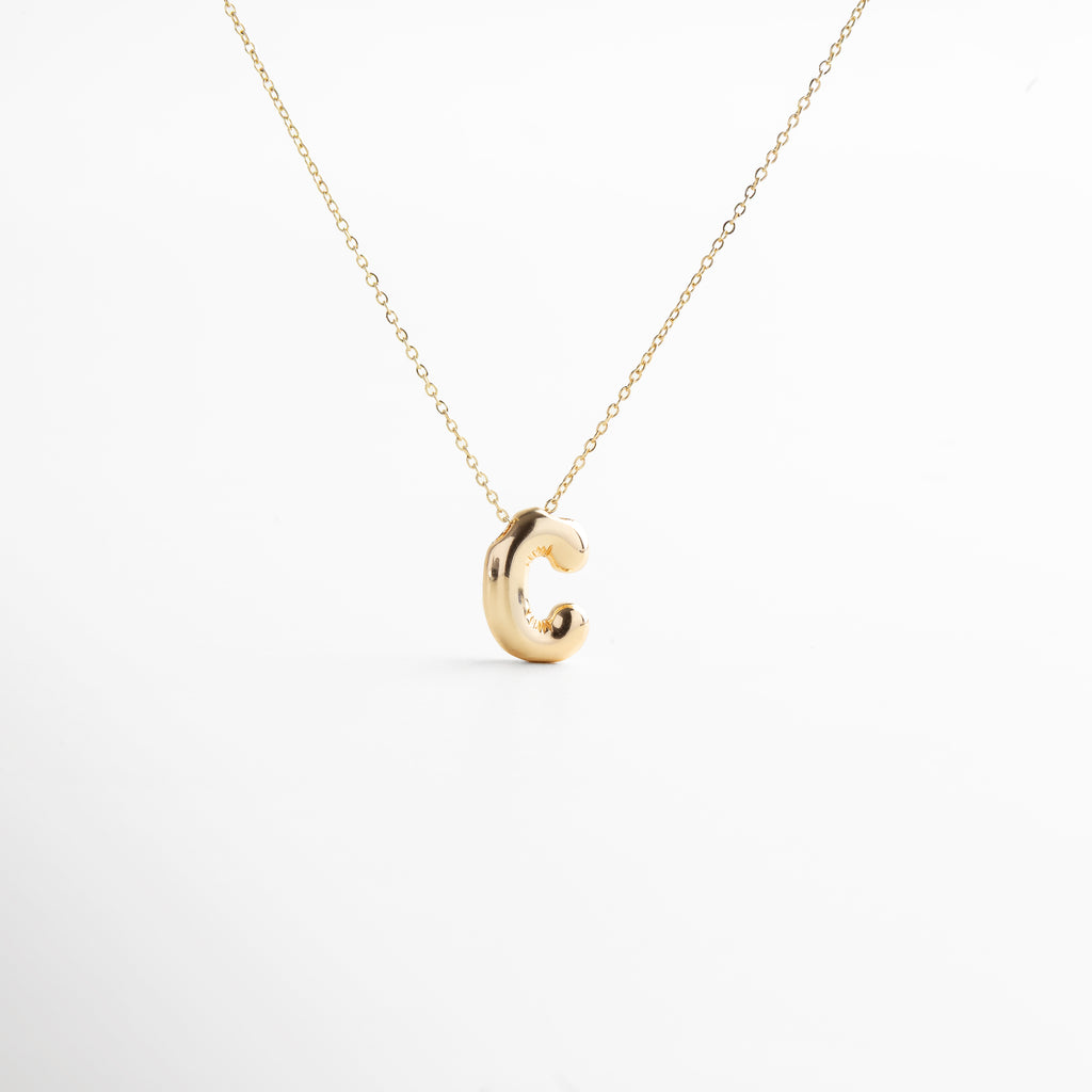 Collar dorado de inicial C con diseño bold y moderno, Inicial C grande en chapa de oro 18K con acabado brillante, Pieza personalizable con significado y estilo atemporal, Letra C central como protagonista del diseño sofisticado, Diseño de cadena fina con punto focal en forma de C