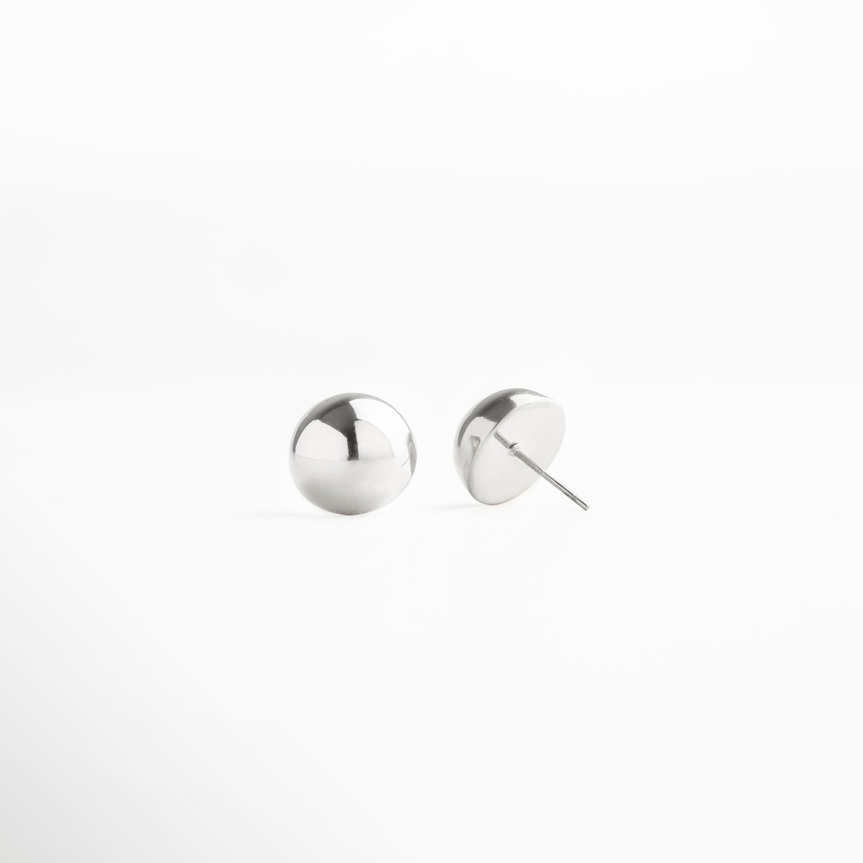 Par de aretes de botón esféricos plateados, diseño sencillo y moderno en acero inoxidable, perfectos para un estilo minimalista y elegante.