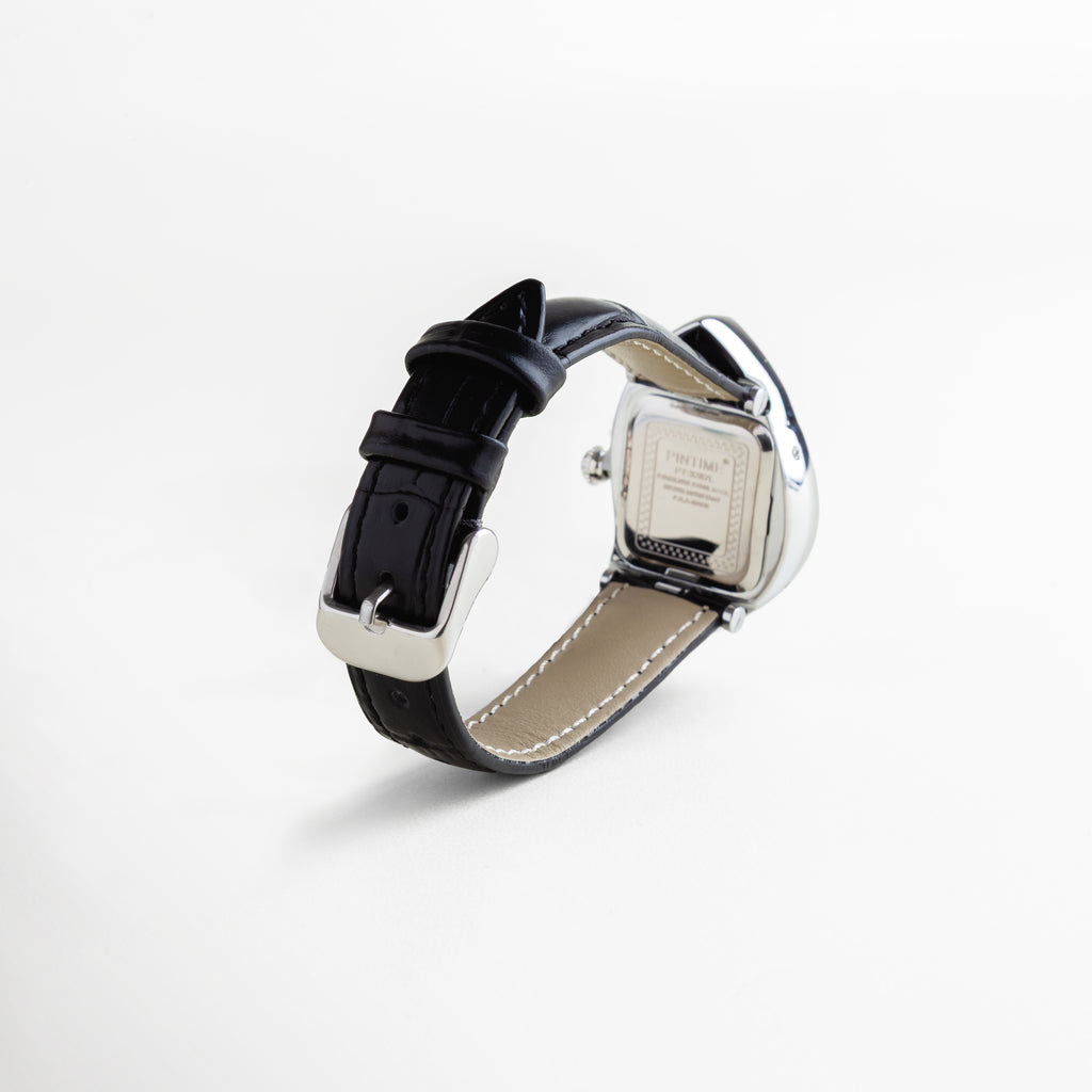 Reloj con correa de piel sintética negra y hebilla metálica, caja trasera en titanio con detalles grabados, diseño de dial surrealista con forma curva y acabado enchapado en oro 18K, accesorio unisex de estilo moderno y artístico.