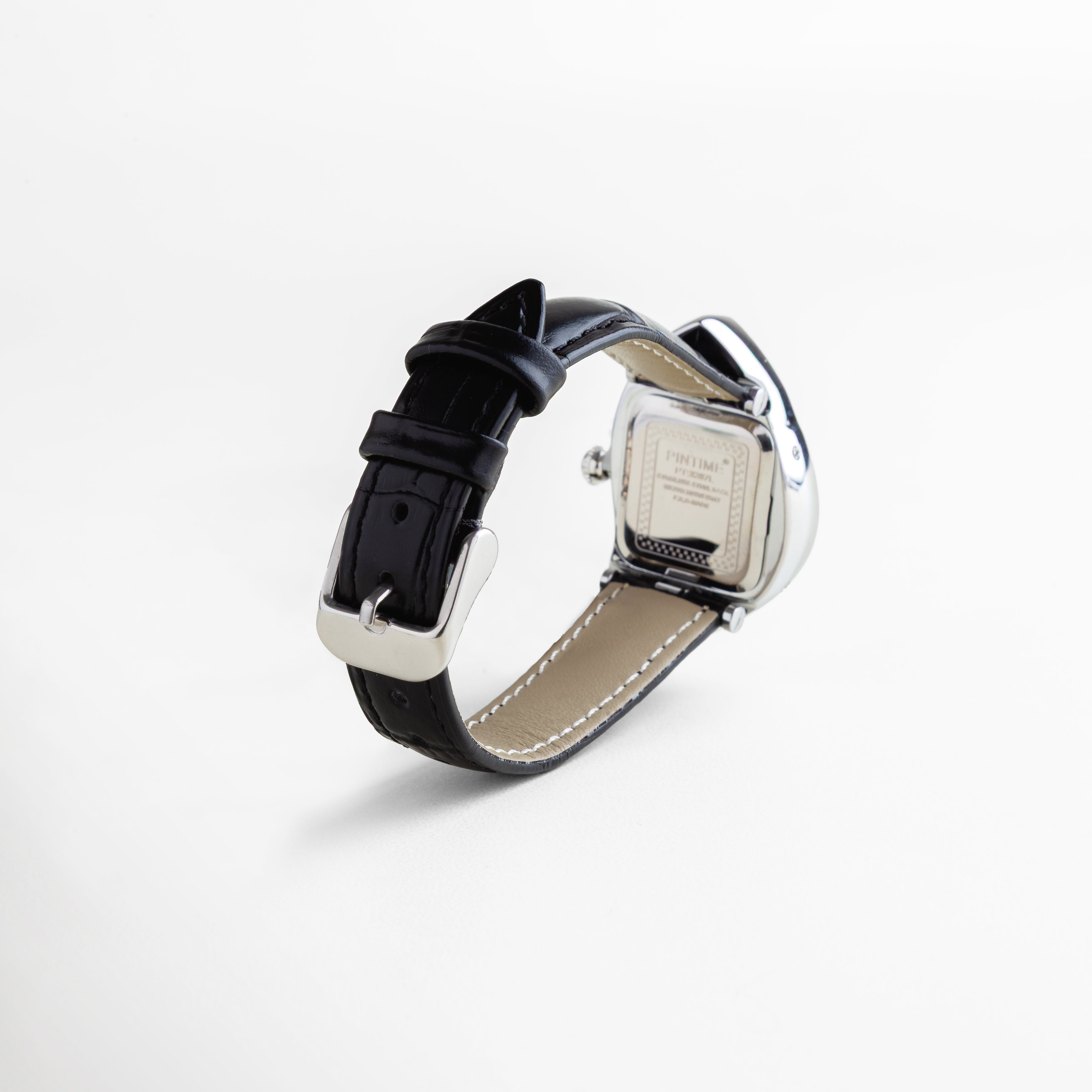 Reloj con correa de piel sintética negra y hebilla metálica, caja trasera en titanio con detalles grabados, diseño de dial surrealista con forma curva y acabado enchapado en oro 18K, accesorio unisex de estilo moderno y artístico.
