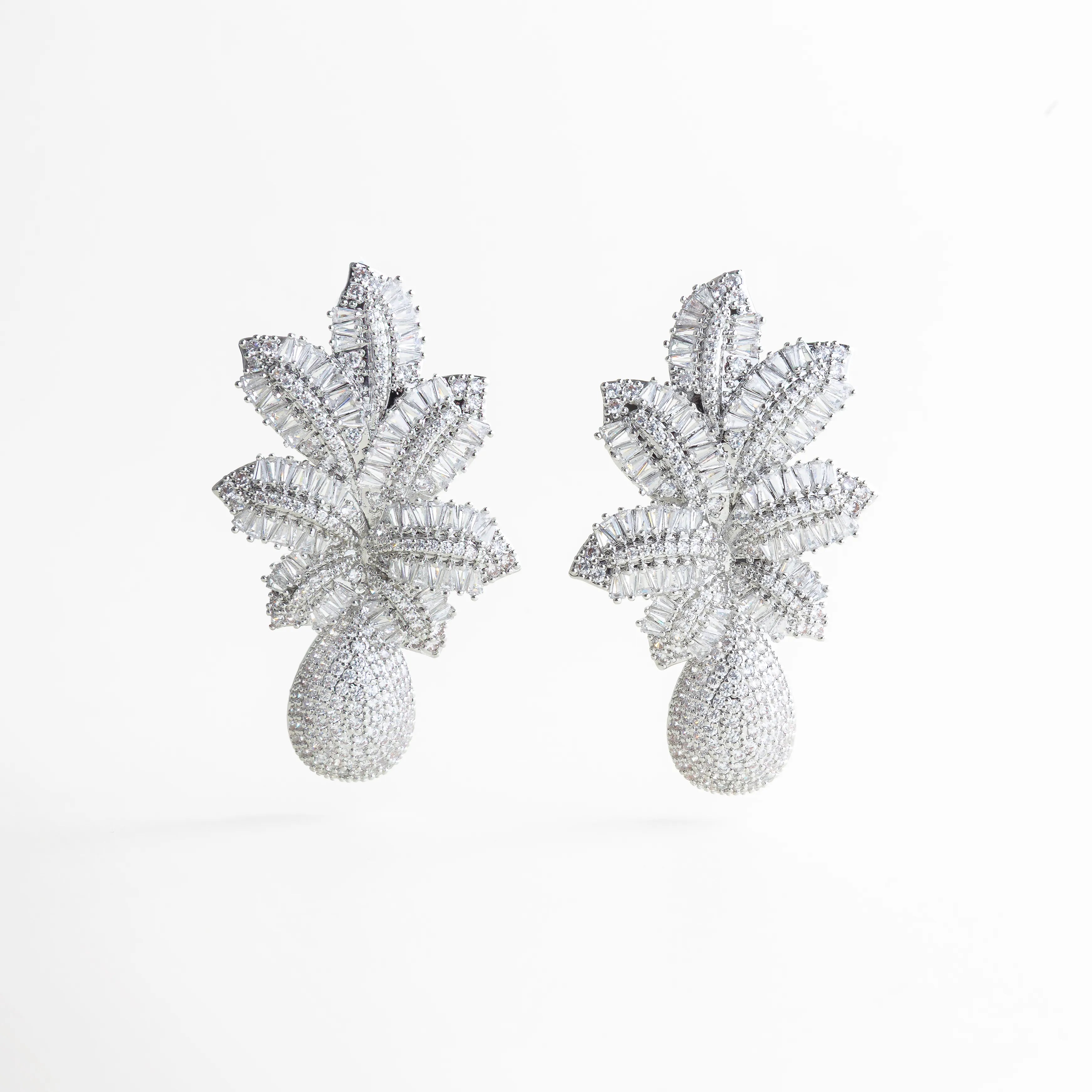 aretes plateados statement de diseño floral volumétrico, aretes largos plateados con textura brillante, joyería statement plateada estilo escultórico, aretes elegantes plateados con formas orgánicas, aretes de impacto plateados para eventos especiales, aretes llamativos plateados con volumen estructural