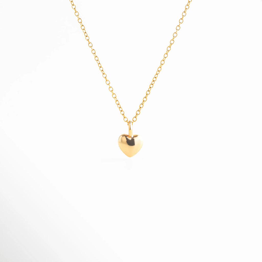 collar bitono vista lateral elegante, perfil de collar con cadena dorada, joyería femenina de líneas suaves, collar moderno con caída delicada, collar sofisticado estilo minimal, joyería contemporánea bitono