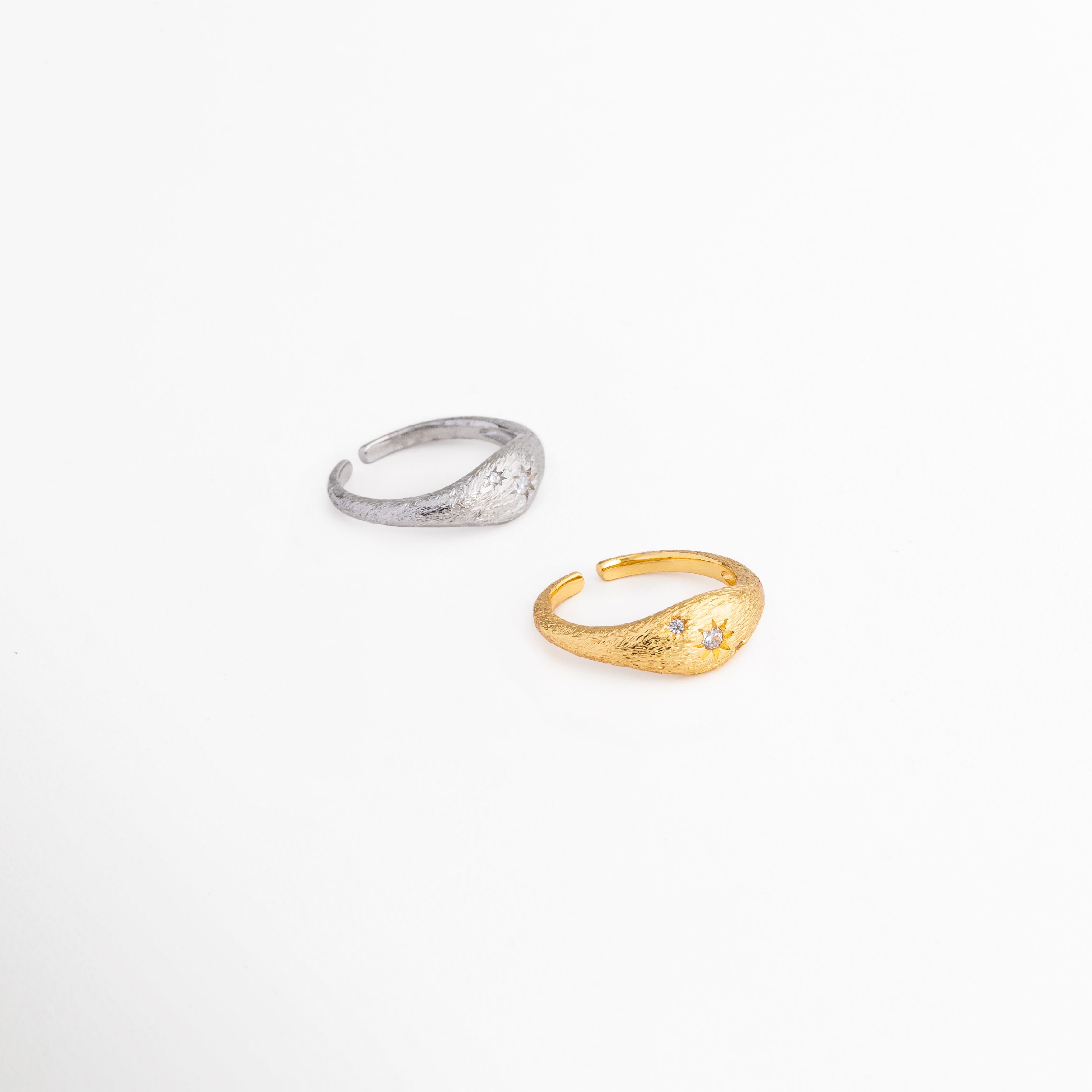 Anillo Solaris disponible en acabados plateado y dorado, Comparativa de colores del anillo Solaris con zirconia, Anillo ajustable en tonos plata y oro para diferentes estilos, Variantes del anillo Solaris con acabado metálico brillante, Anillo minimalista disponible en versión plateada y dorada.