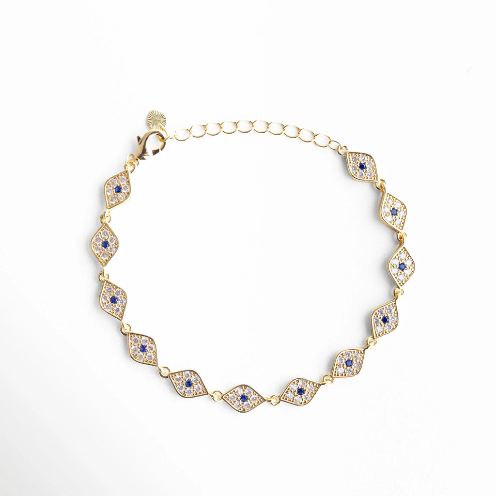 Pulsera dorada con diseño de ojo turco y zirconias, estilo elegante y amuleto de protección, Pulsera Code Ojitos en chapa de oro 18K con zirconias, diseño místico y sofisticado, Pulsera dorada con múltiples ojos turcos y brillo de zirconias, accesorio elegante de protección, Pulsera fina de 18 cm con detalles de ojo turco y acabado en oro 18K, Joyería dorada tipo pulsera con ojos turcos y zirconias brillantes, estilo moderno y espiritual