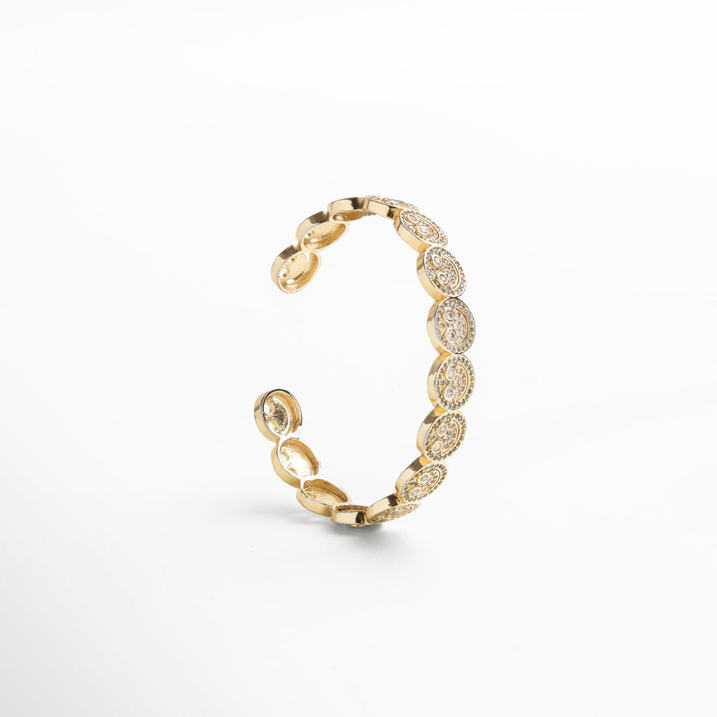 reflejo de luz sobre caritas doradas con zirconias, textura metálica en caritas con incrustaciones brillantes, destellos dorados sobre diseño de caritas felices, contraste de brillo entre dorado y zirconia cúbica, efecto brillante en motivos de caritas sonrientes