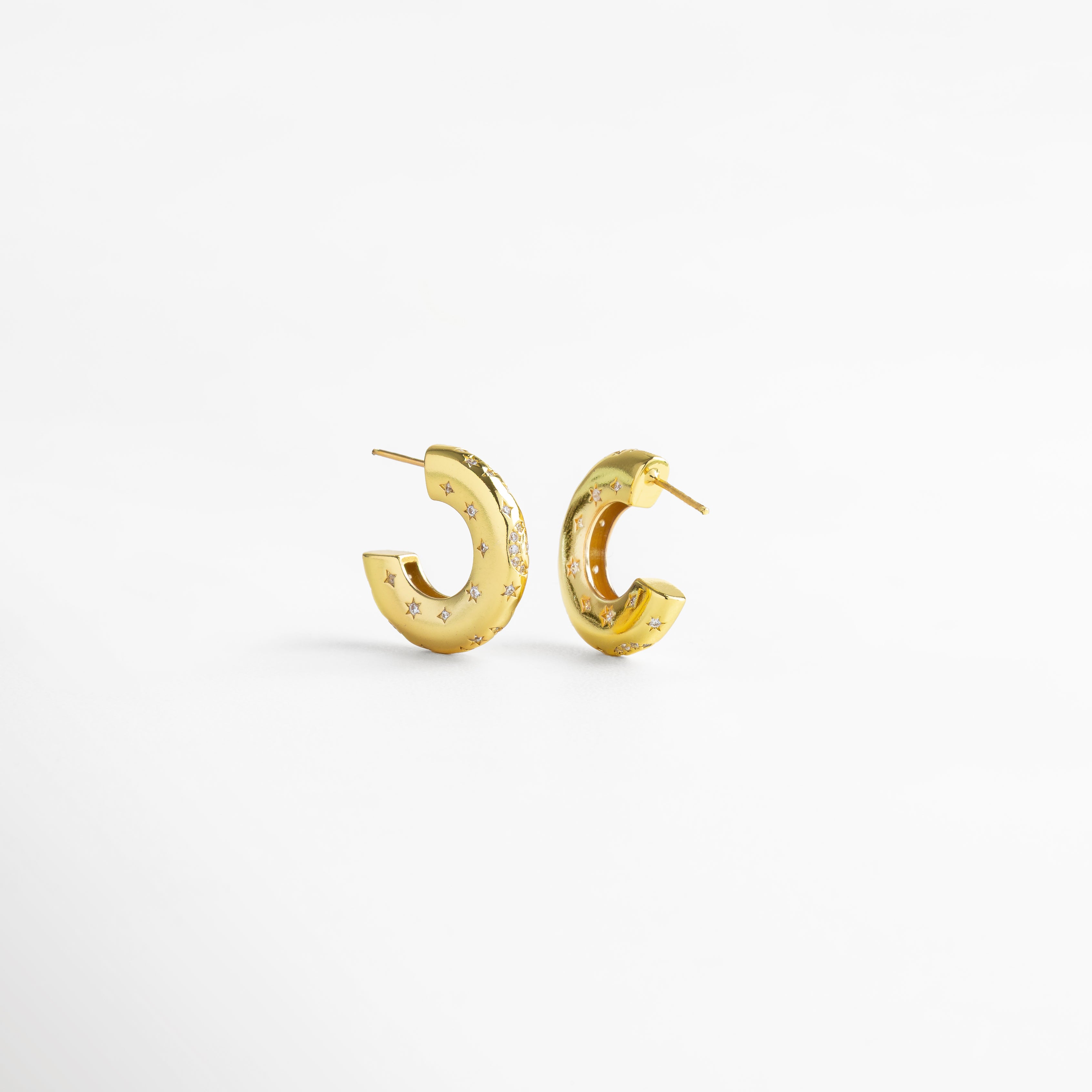 Aretes de aro en cobre con recubrimiento en oro 18K e incrustaciones de diamantes de imitación, diseño grueso de 2 cm de largo y 0.5 cm de ancho con grabado de estrellas, joya moderna y elegante que simboliza fuerza y confianza.