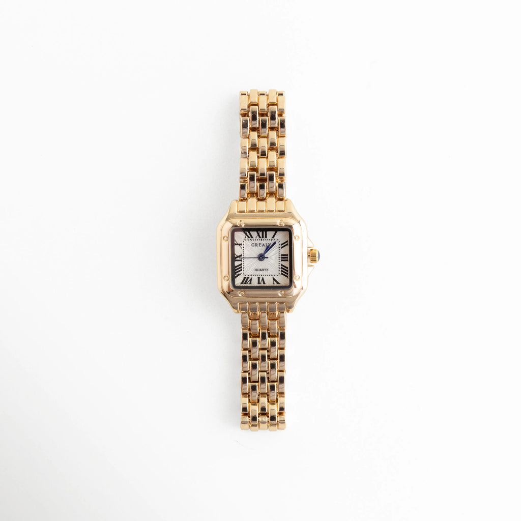 Reloj de mujer con carátula cuadrada y acabado dorado, diseño elegante y sofisticado, Vista frontal de reloj femenino en acero inoxidable con acabado en oro y estilo refinado, Reloj elegante para mujer con carátula pequeña y acabado brillante en tono dorado, Carátula de reloj femenino con diseño delicado y estructura moderna en acero inoxidable dorado, Reloj sofisticado para mujer con acabado en oro y estilo atemporal para cualquier ocasión.